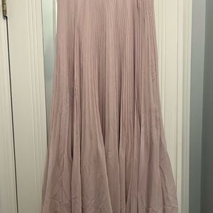 Brand new light pink high-rise midi skirt with an elastic waist and pleats.